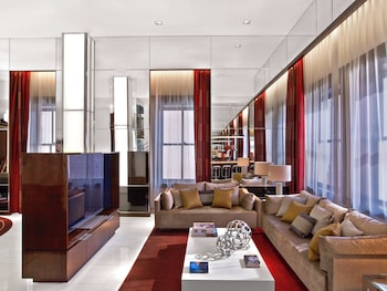 Relax in a spacious living area with a large flat-screen TV, comfortable sofa, and modern kitchen. at The Joule