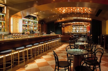 Enjoy a drink at the bar, where stools and a counter offer a place to sit and socialize. at The Joule