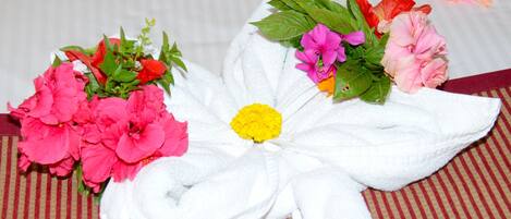 A towel with a floral design, placed on a striped surface.