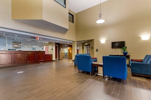 A spacious lobby with a reception desk, seating area, and a television screen. - Comfort Inn & Suites Cambridge (Cambridge)