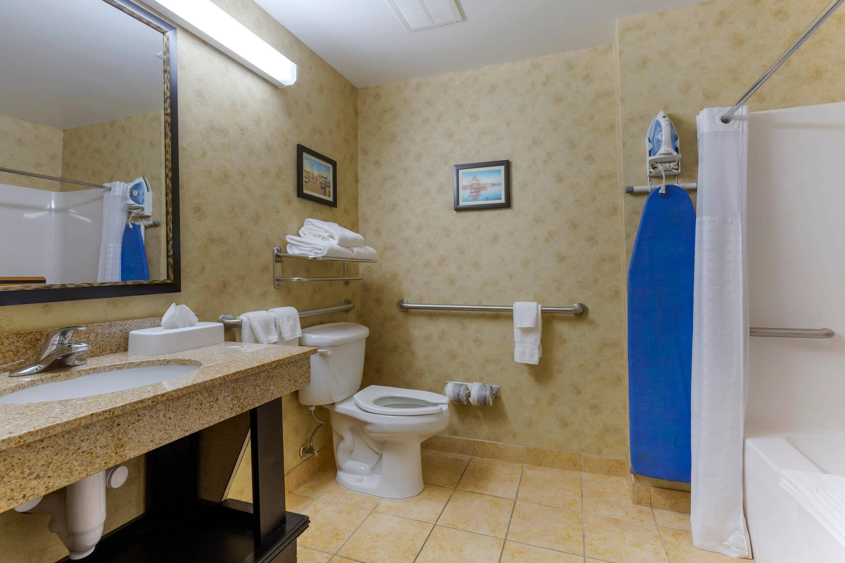 A bathroom with a sink, toilet, and shower.