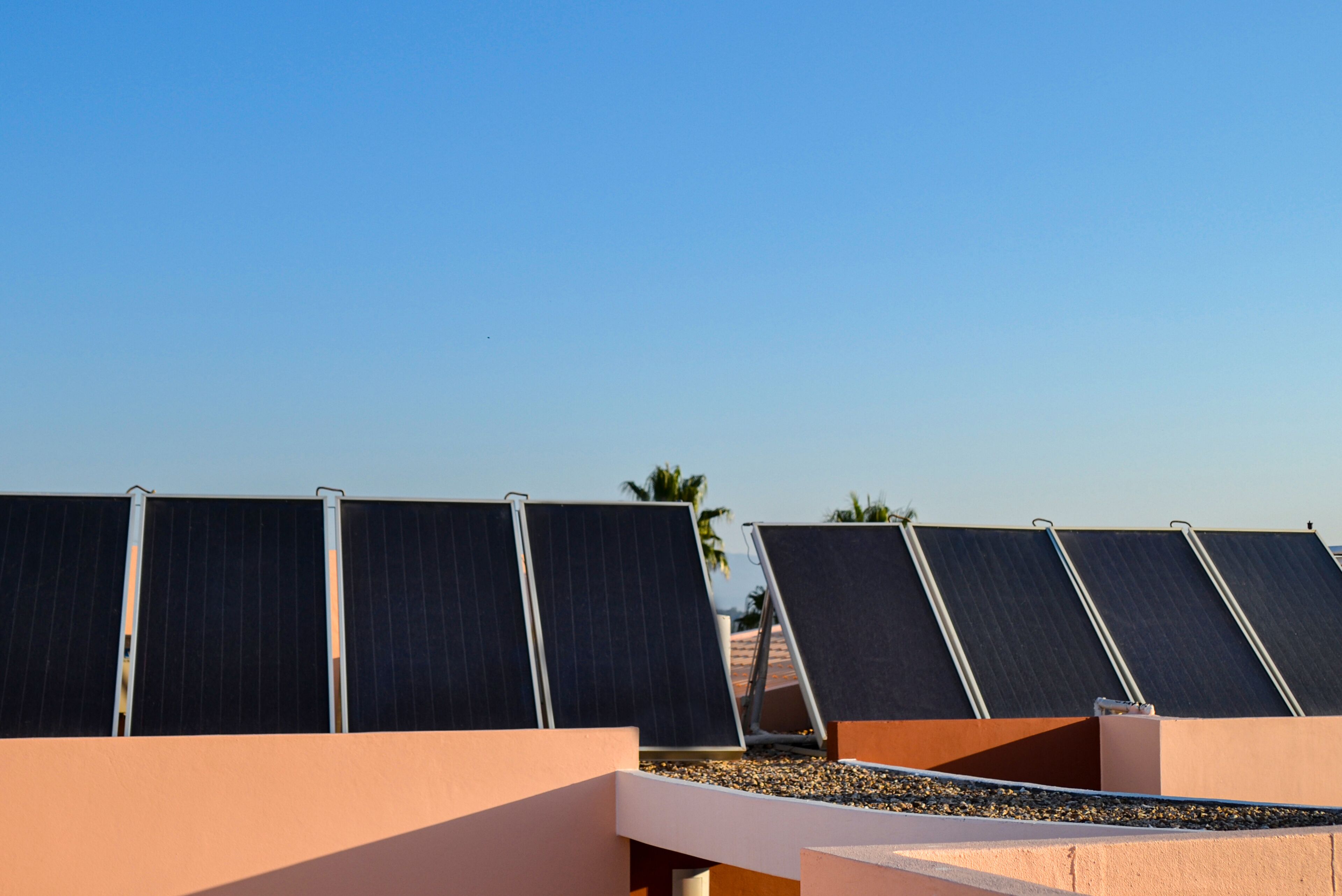 Solar panels on a rooftop with a clear sky.