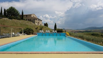 Seasonal outdoor pool, open 6:00 AM to 9:00 PM, pool umbrellas