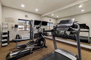 A fitness center with treadmills, an elliptical, and a stationary bike.