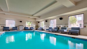 A swimming pool with blue tiles and a series of blue chairs along the edge. - Hampton Inn & Suites Ft. Worth-Burleson (Burleson)