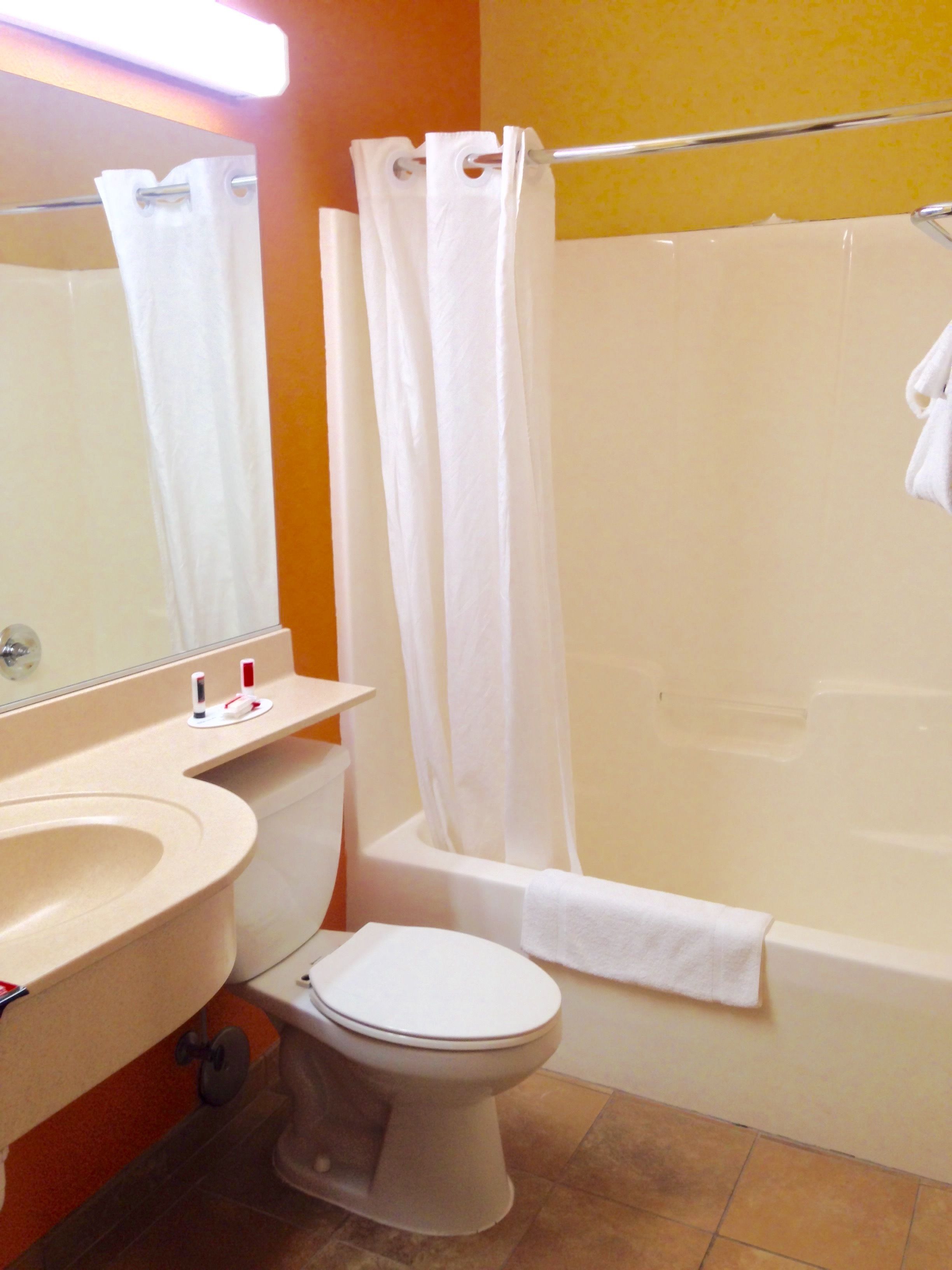 A bathroom with a toilet, sink, and bathtub.