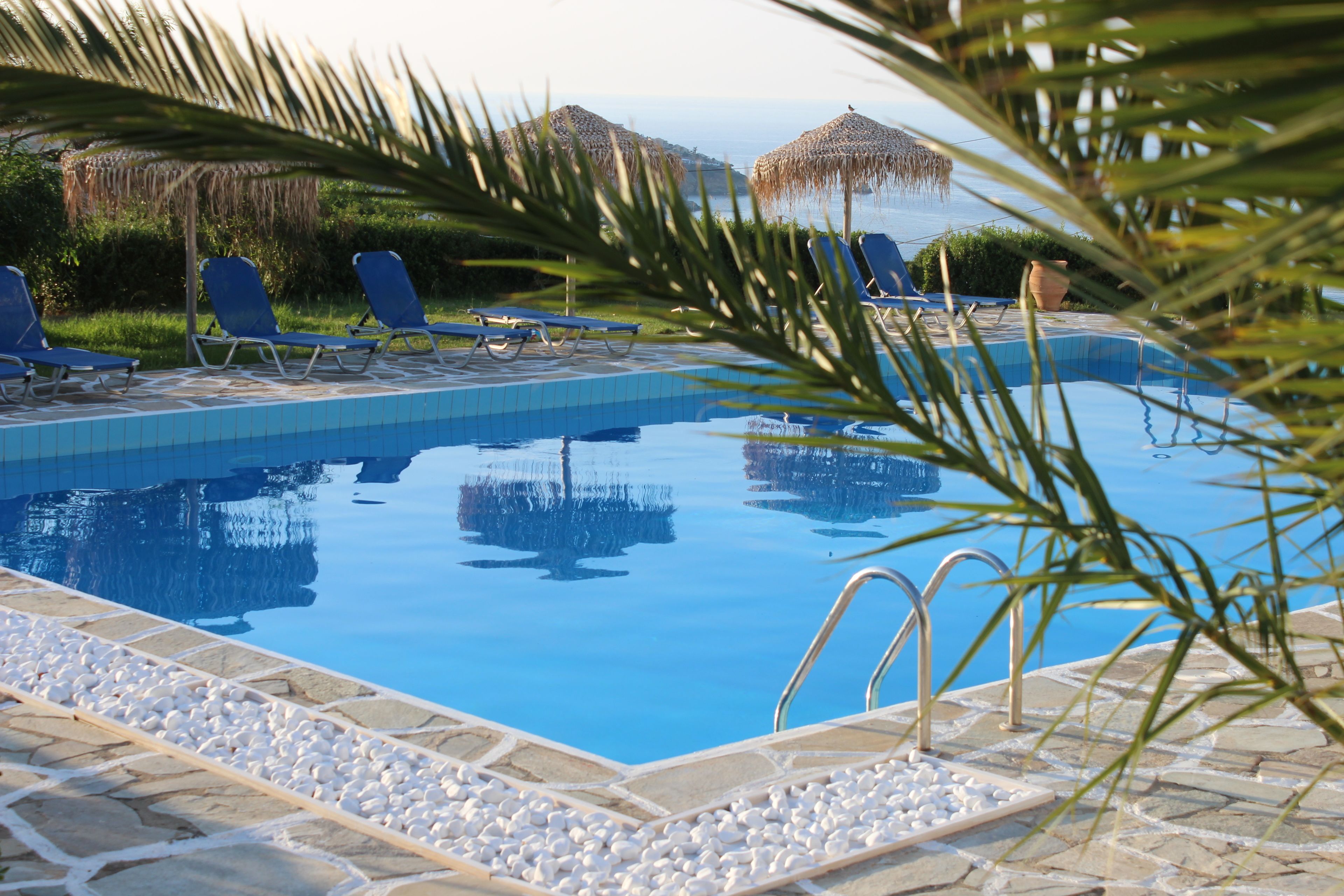 Seasonal outdoor pool, an infinity pool, pool umbrellas, sun loungers
