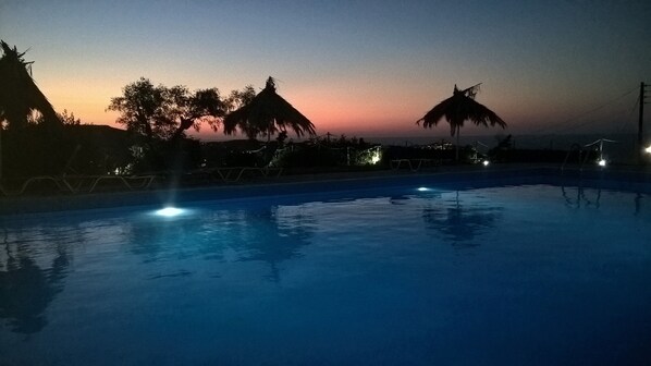 Seasonal outdoor pool, an infinity pool, pool umbrellas, pool loungers