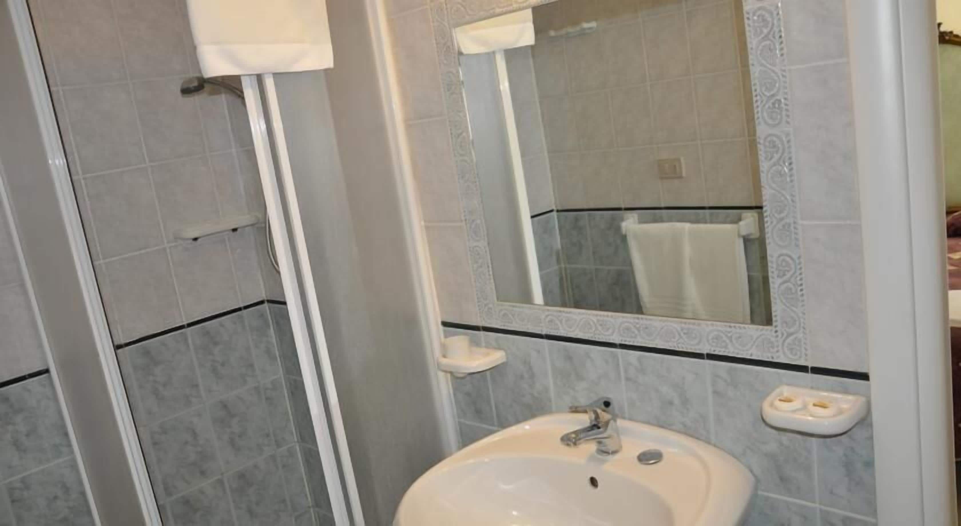 designer toiletries, hair dryer, bidet, towels