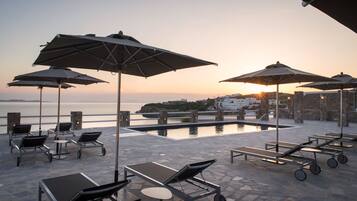 Seasonal outdoor pool, open 11:00 AM to 7:00 PM, pool umbrellas