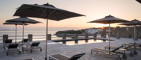 Seasonal outdoor pool, open 11:00 AM to 7:00 PM, pool umbrellas