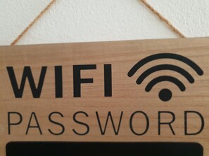 A wooden sign with "WIFI PASSWORD" written on it. - Hotel Castello di Tavolara (Loiri Porto San Paolo)