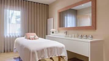 Relax in a serene space with a neatly made bed, large mirror, and modern vanity.
