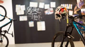 Una bicicleta con un casco en el asiento, una pared con mensajes y un cartel en una habitación.