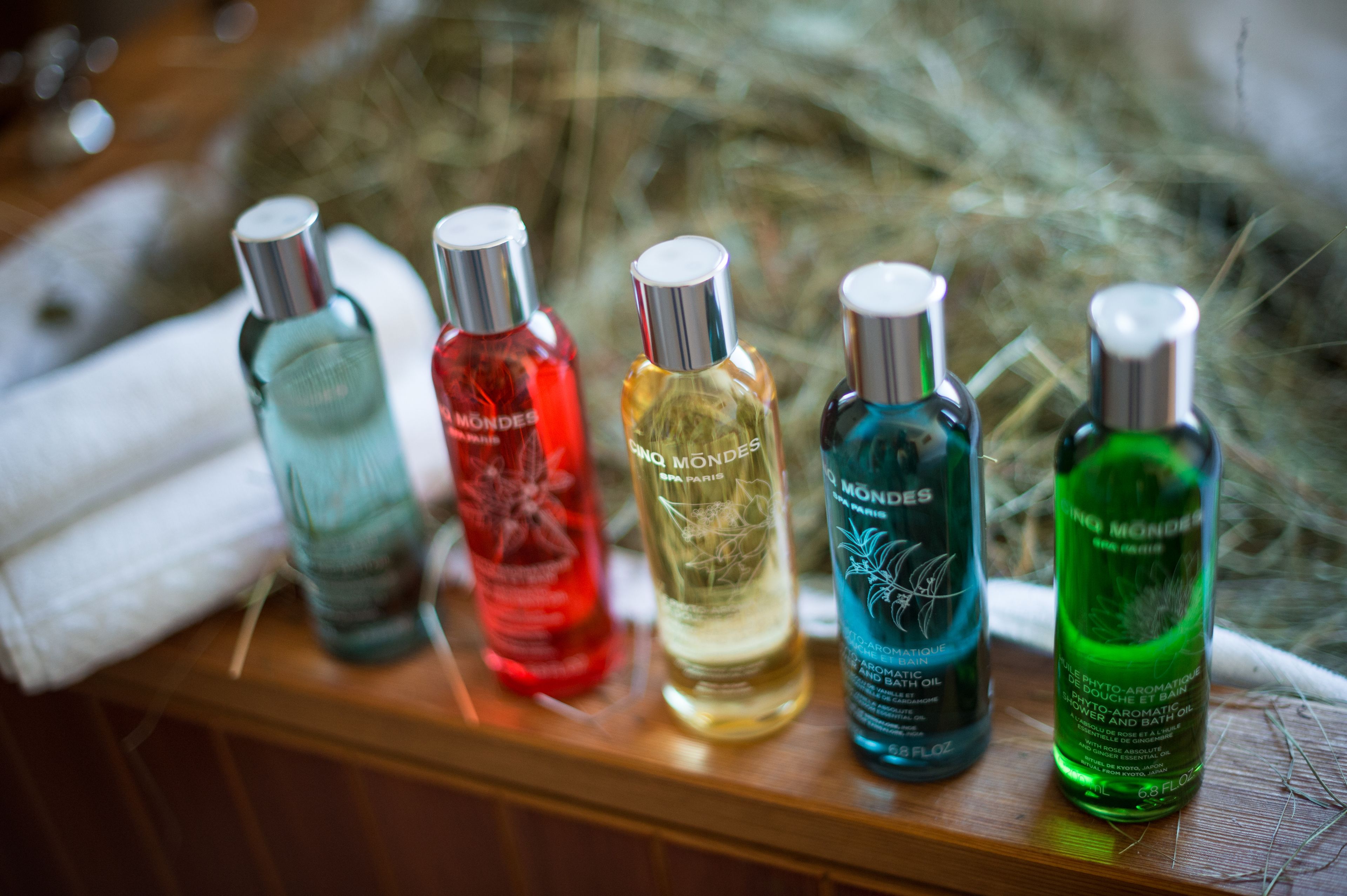 A row of perfume bottles on a wooden surface.