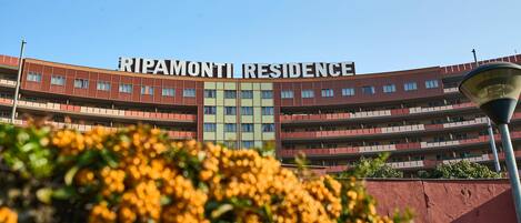 A multi-story building with the sign "RIPAMONTI RESIDENCE" on the facade.