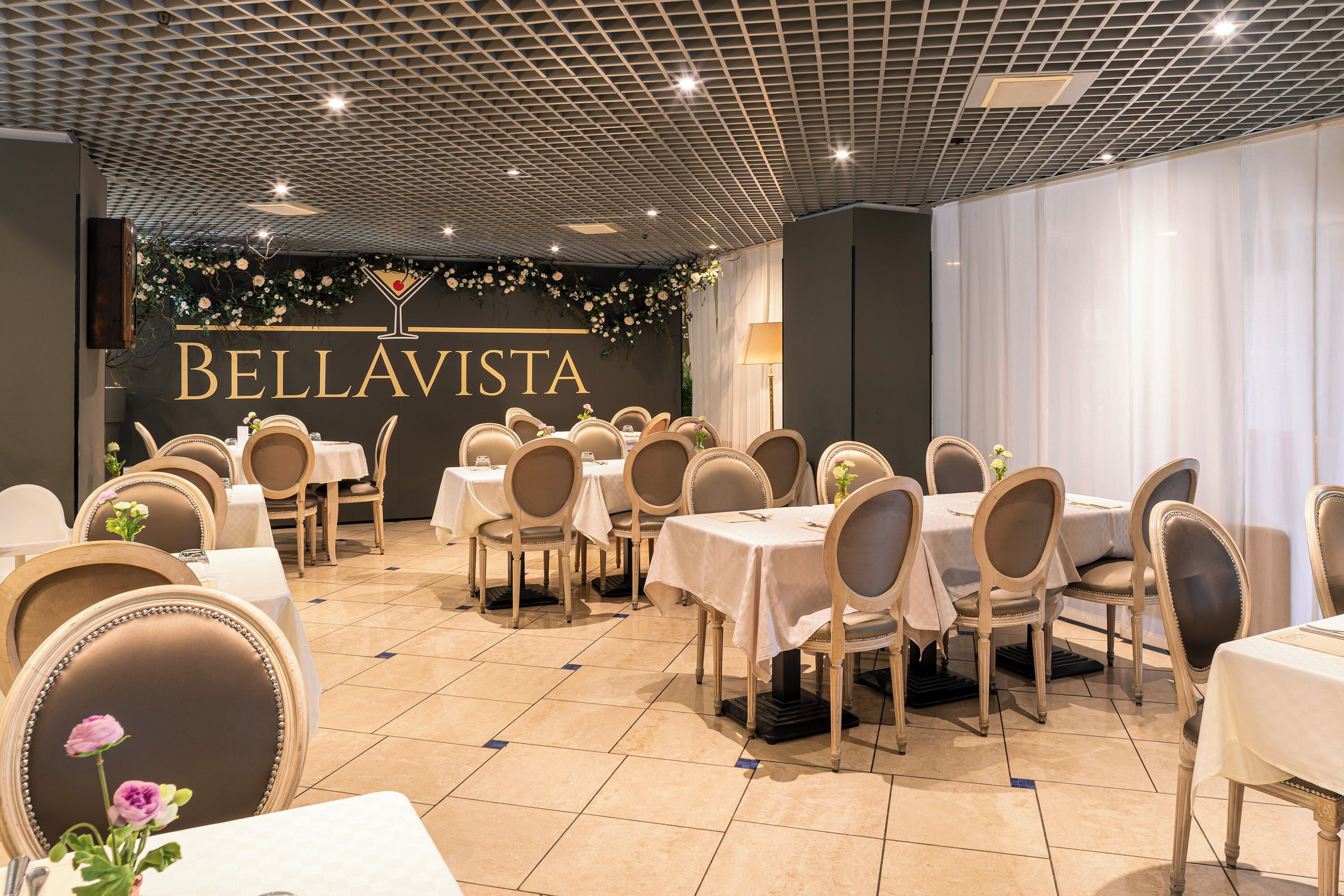 A restaurant interior with tables and chairs arranged for dining.