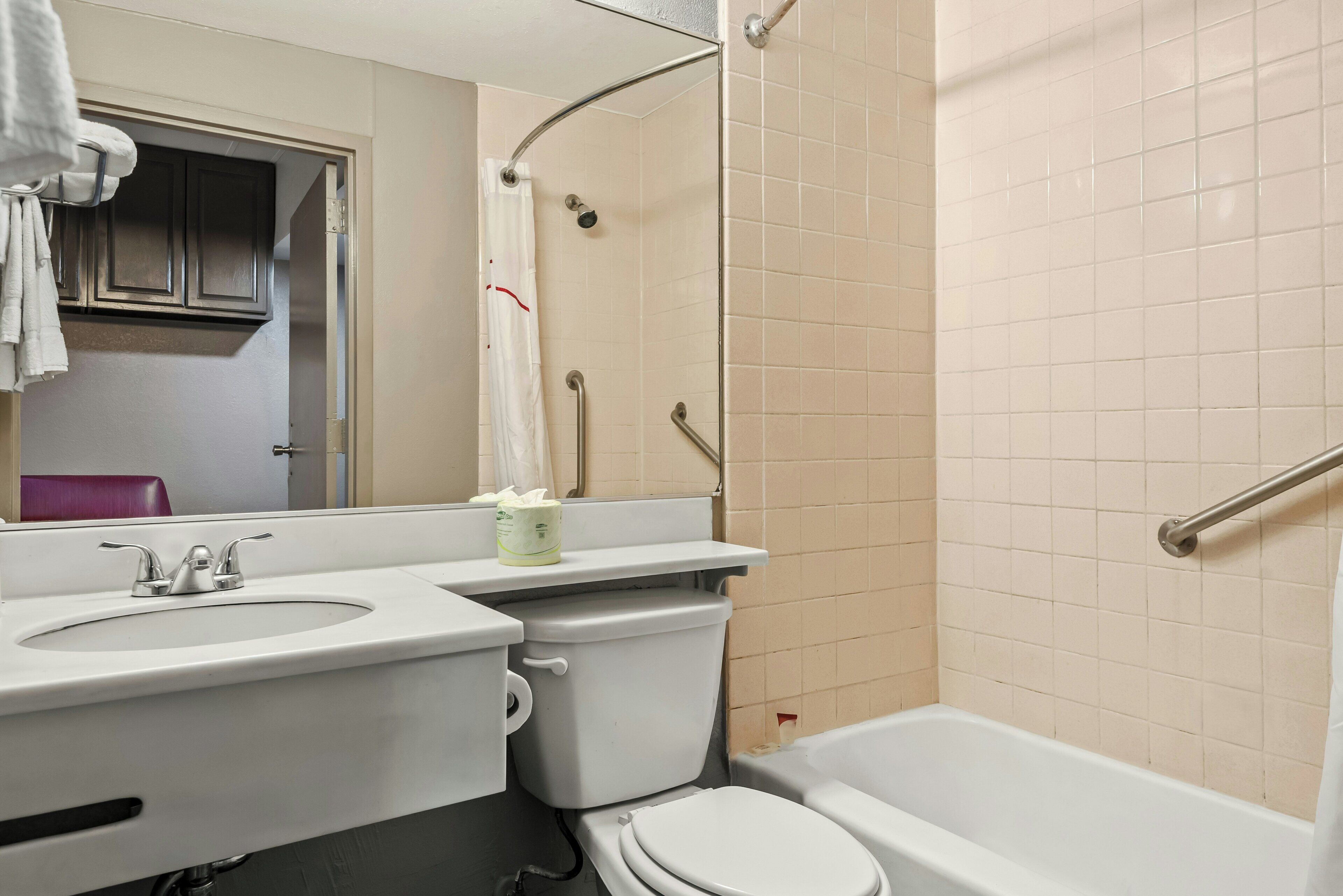 A bathroom with a toilet, sink, and bathtub.
