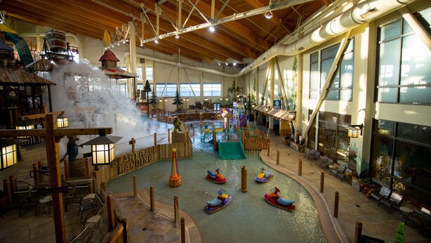 An indoor water park with a lazy river, wooden structures, and various water features. - Great Wolf Lodge Grand Mound (Centralia)