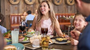 A restaurant interior with wooden walls, tables, and various dishes. - Great Wolf Lodge Grand Mound (Centralia)
