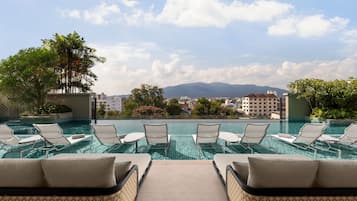 Outdoor pool, open 7:00 AM to 7:00 PM, pool umbrellas