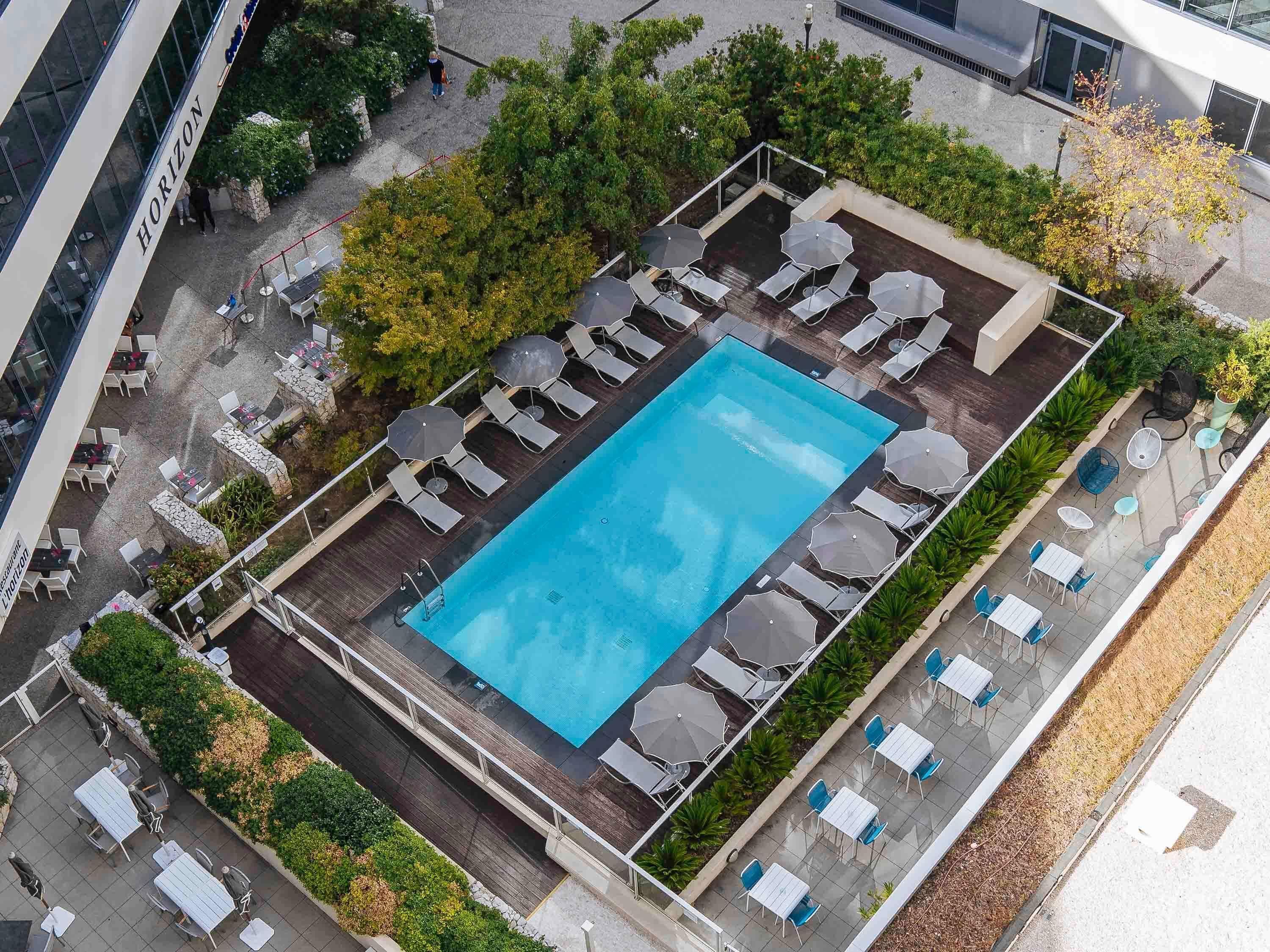 outdoor pool, open 9:00 am to 8:00 pm, pool umbrellas, pool loungers