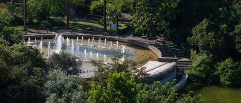 A park with a fountain, walking paths, and a gazebo.