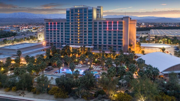 A large hotel with multiple floors, a swimming pool, and a parking area. - Agua Caliente Casino Rancho Mirage (Rancho Mirage)