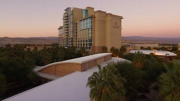 A high-rise hotel with a modern design, featuring multiple balconies and a prominent glass facade.