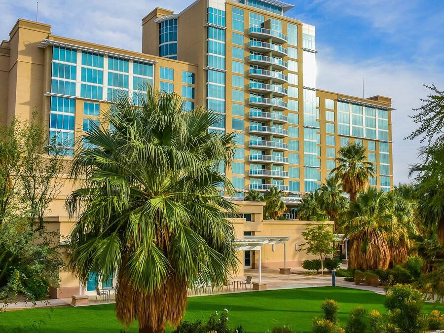 A multi-story hotel with a modern design, featuring large windows and balconies.
