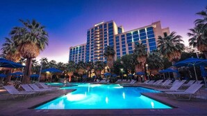 A hotel with a swimming pool surrounded by palm trees and lounge chairs. - Agua Caliente Casino Rancho Mirage (Rancho Mirage)