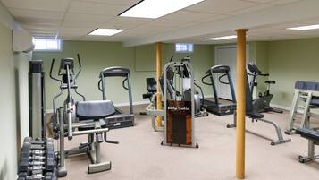 A gym with various exercise machines, a treadmill, and a stationary bike.