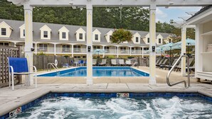 A pool area with a hot tub, lounge chairs, and a covered seating area. - The Admiral's Inn Resort (Ogunquit)