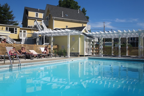 Seasonal outdoor pool, open 9 AM to 9:00 PM, pool umbrellas