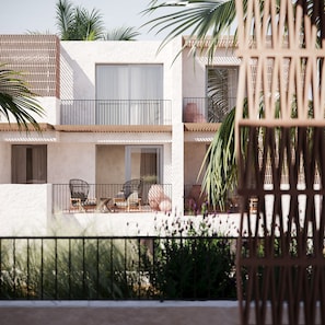 A multi-story building with balconies, outdoor seating, and palm trees. - VOI Vila do Farol Resort (Sal)