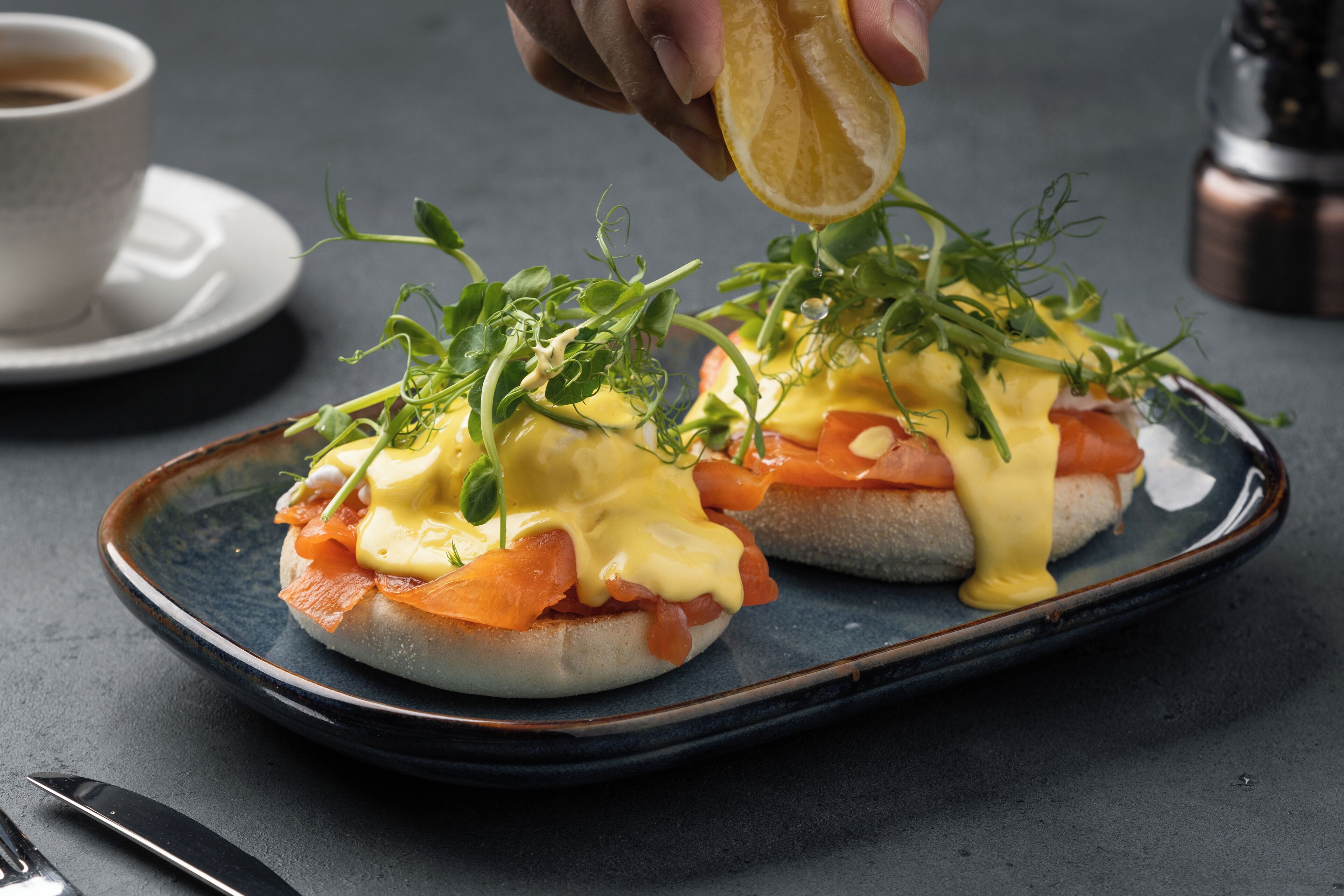 A breakfast dish with eggs and smoked salmon on a plate.