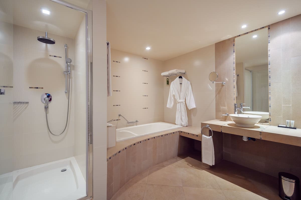luxury suite | bathroom | separate bathtub and shower, free toiletries, hair dryer, towels