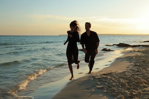 On the beach, white sand, sun-loungers, beach umbrellas