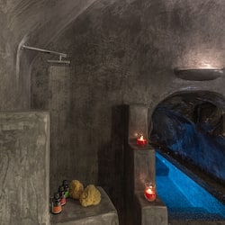Experience tranquility in this serene spa room, featuring a soothing water feature and candles.