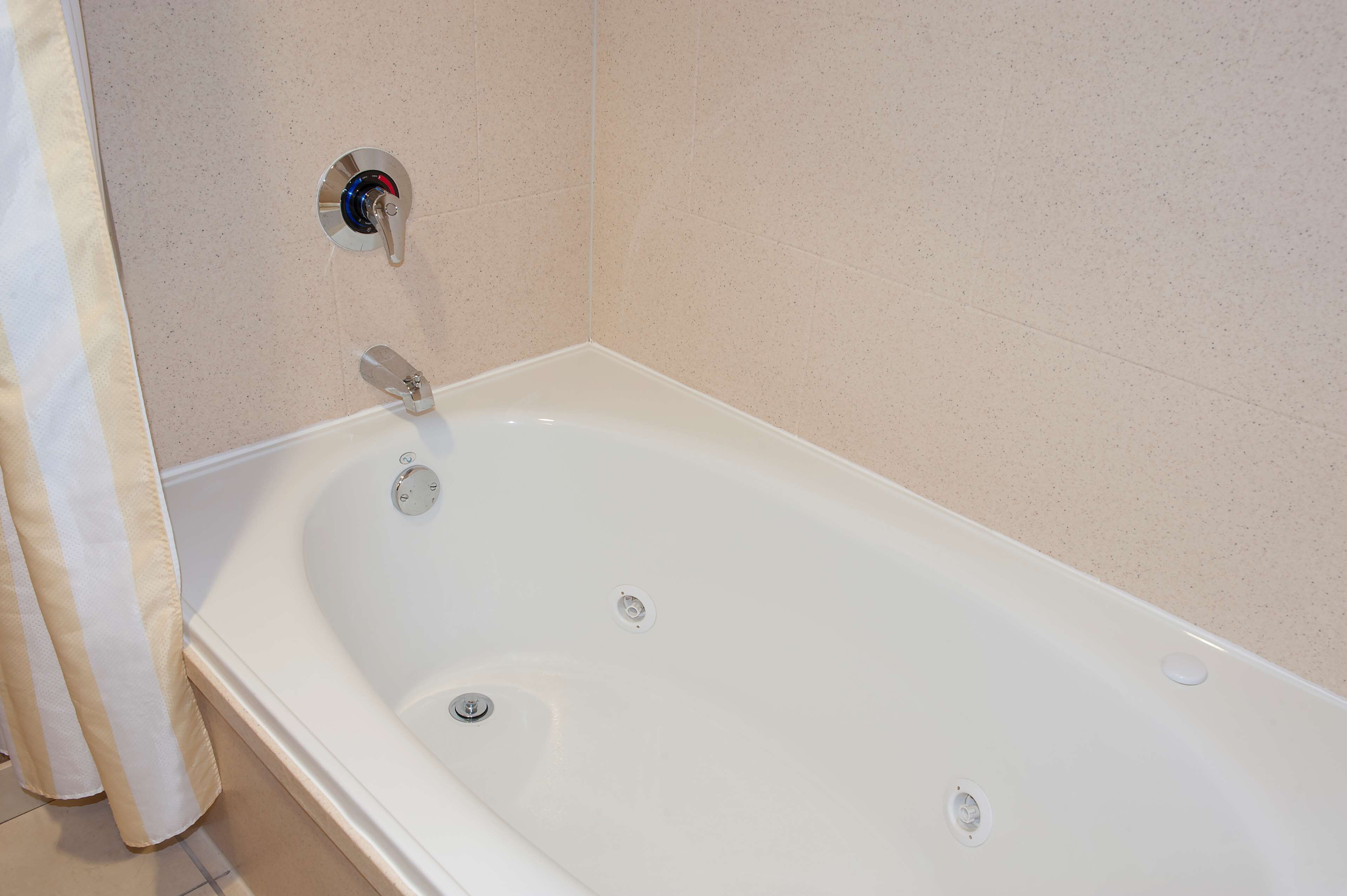 with jetted tub | bathroom | hair dryer, towels