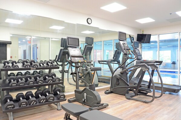 A gym with treadmills, elliptical machines, and a rack of dumbbells. - Holiday Inn Express & Suites Millington by IHG (Millington)