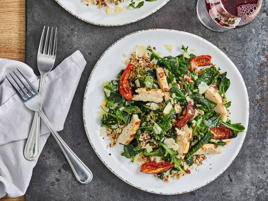 A plate of food with a fork and knife on a napkin.