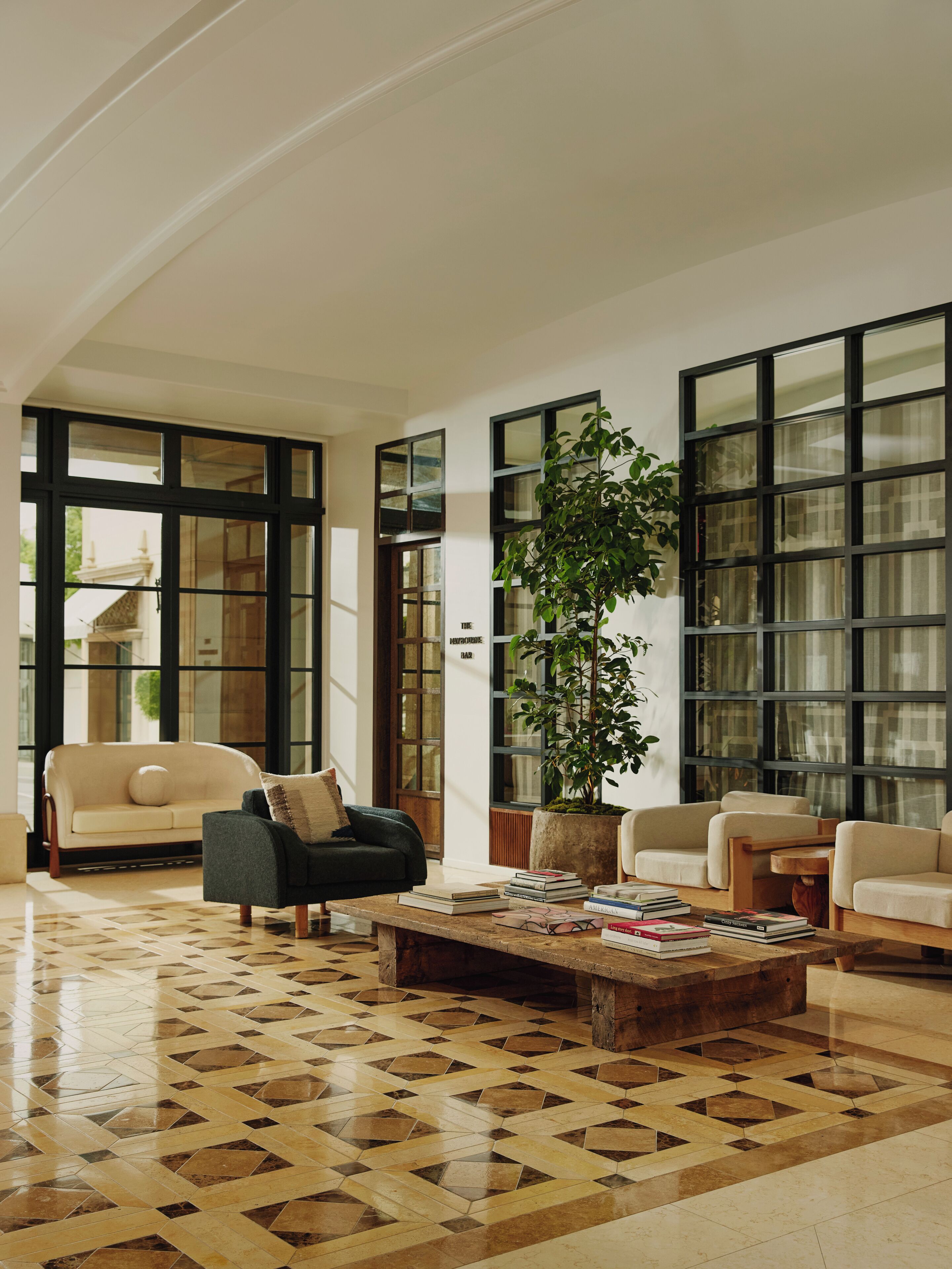 A spacious living room with a large window, a coffee table, and a sofa.