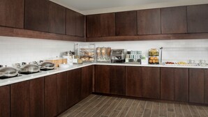 A modern kitchen with dark wooden cabinets, white subway tiles, and stainless steel appliances. - Residence Inn by Marriott Birmingham/Hoover (Birmingham)