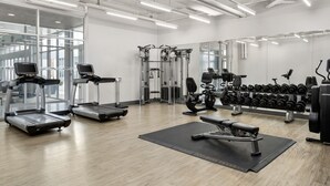 A modern gym with treadmills, weight machines, and a bench. - Aloft by Marriott Chicago O'Hare (Rosemont)