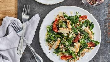 A plate of food with a fork and napkin on a table.