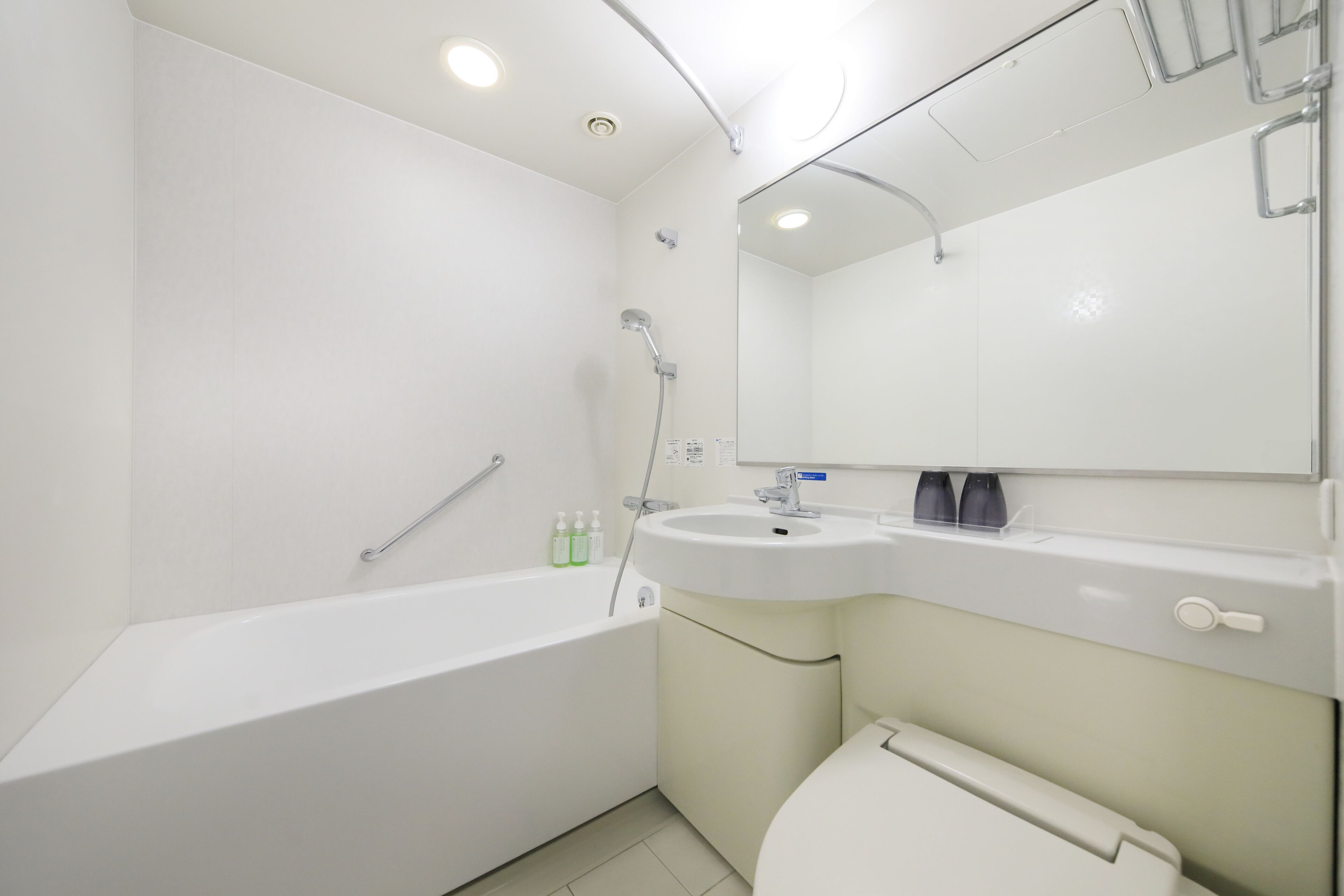 A modern bathroom with a bathtub, sink, and toilet.