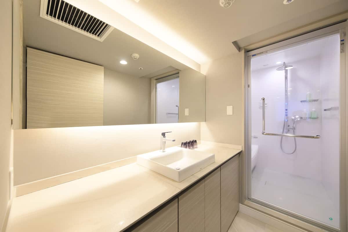 junior suite | bathroom | separate bathtub and shower, hair dryer, electronic bidet, towels