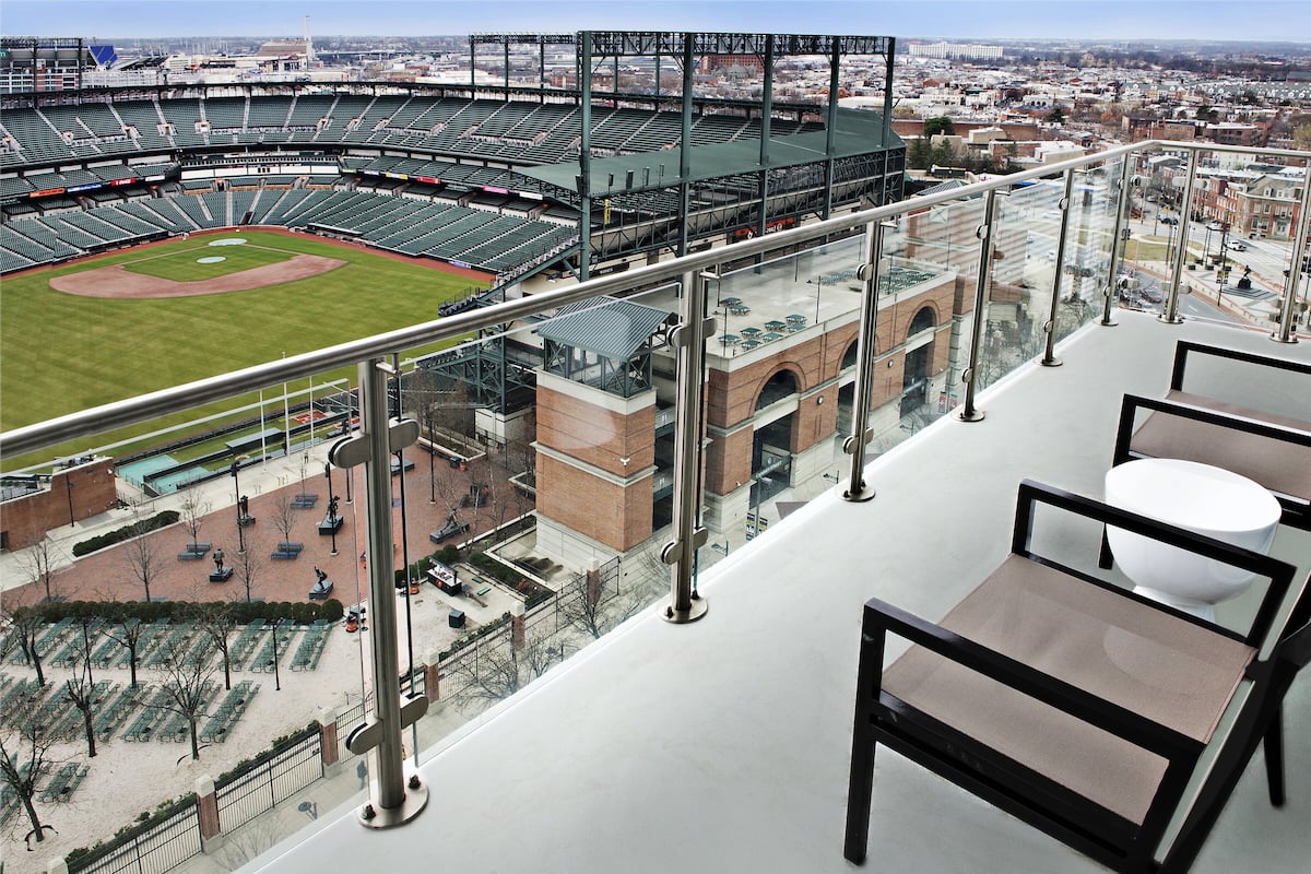 A high-rise hotel room with a view of a baseball stadium.