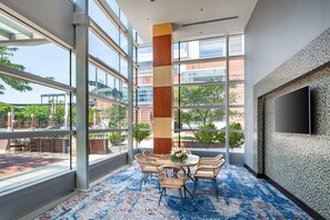 A spacious room with large windows, a high ceiling, and a modern design. - Hilton Baltimore Inner Harbor (Baltimore)